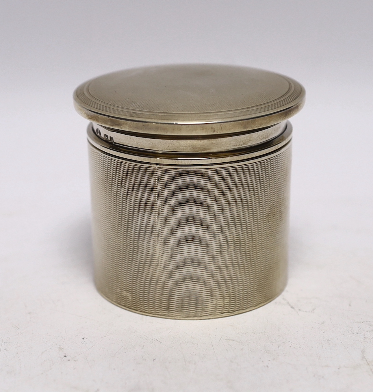 A George V engine turned silver toilet canister and cover by Adie Bros. Birmingham, 1930, height 76mm, 5oz.